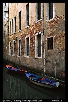 Small boats moored along a wall