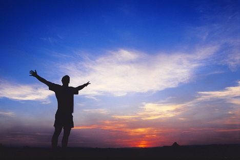 inspired-utah-man-silhouette-with-arms-raised-into-sunset-sky