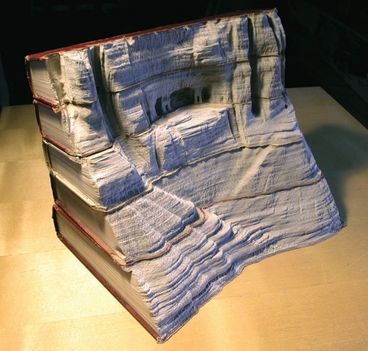 Guy Laramee, Quebecben élő kanadai művész, elképesztő térhatású látképeket farag ki egymásra rakott könyvekvől. A könyvkupaccal úgy bániik, mintha egy márványtömb lenne. 1